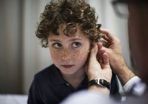 Young boy having his ears fitted for hearing aids, INfinity hearing